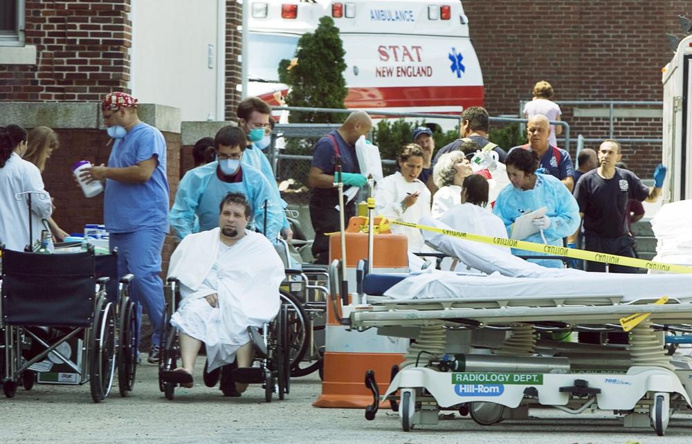 Medical personnel tend people outside St. Luke's Hospital who had been brought there after being exposed to unknown fumes at a trash disposal company in New Bedford on Monday. (AP)