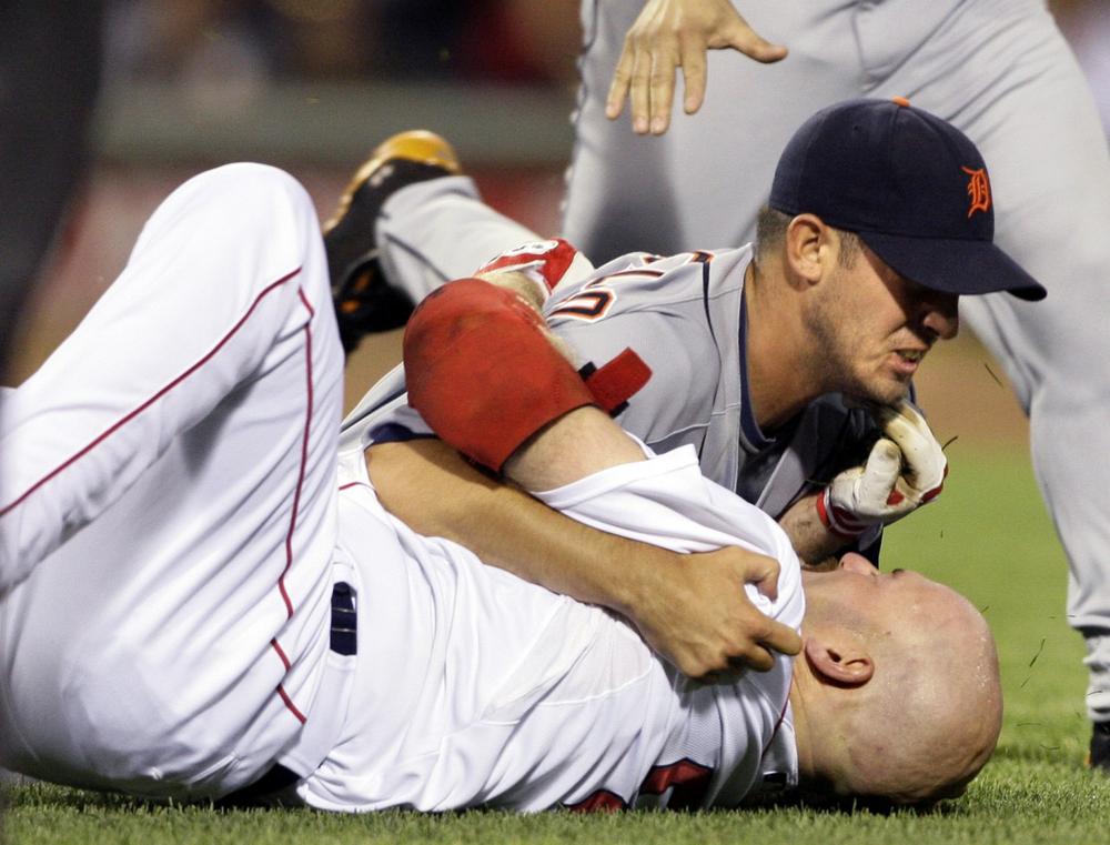 Boston's Kevin Youkilis, below, wrestles with Detroit Tigers starter Rick Porcello after being hit by a pitch  in the second inning of a baseball game at Fenway Park in Boston, Tuesday. (AP) 