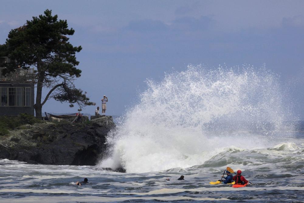 A heavy surf was generated by Hurricane Bill on Sunday in Cape Elizabeth, Maine. A large wave in Maine's Acadia National Park swept five people into the sea. (AP)