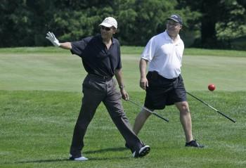 President Obama walks with Dr. Eric Whitaker as they play golf in Oak Bluffs on Monday. (AP)