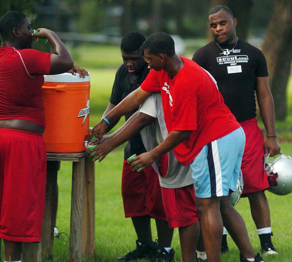 Provine High football players drink water to combat the heat during high school football practice Monday, Aug. 3, 2009, in Jackson, Miss.  (AP Photo/The Clarion-Ledger,Vickie D. King)