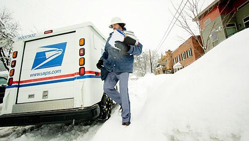 US Postal Service employee Rick Cadwallader makes his mail deliveries in Spokane, Wash. on Tuesday, Jan. 6, 2009. (AP Photo/Young Kwak)