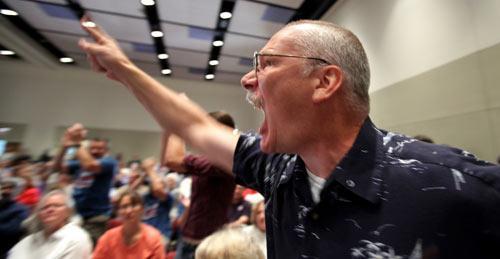 Randy Hook, 50, of Hopewell, Pa., yells at Sen. Arlen Specter, D-Pa., during a town hall meeting on health care in a Penn State University ballroom in State College, Pa, Wednesday, Aug. 12, 2009. More than 400 attended. Opponents occasionally drowned out the Republican-turned-Democrat. (AP Photo/Carolyn Kaster)