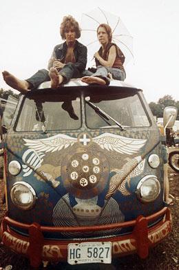 In this Aug. 1969 file photo, concert-goers sit on the roof of a Volkswagen bus at the Woodstock Music and Arts Fair at Bethel, N.Y. (AP Photo)