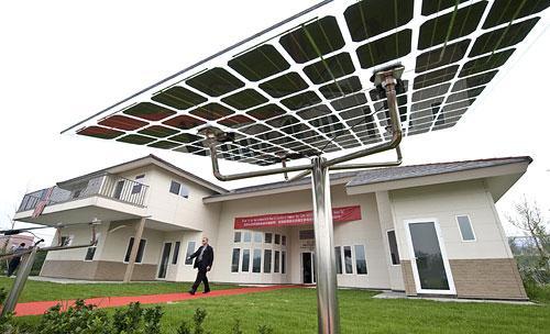 A U.S. delegate walk past solar panels on display outside a Future House, a clean energy resident development project in Beijing, China, on July 16, 2009. (AP)