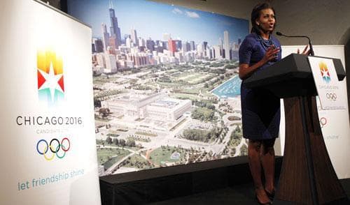 Standing in front of a backdrop of the Chicago skyline, U.S. first lady Michelle Obama speaks at a dinner in support Chicago hosting the 2016 Summer Olympics, Wednesday, Sept. 30, 2009, in Copenhagen.