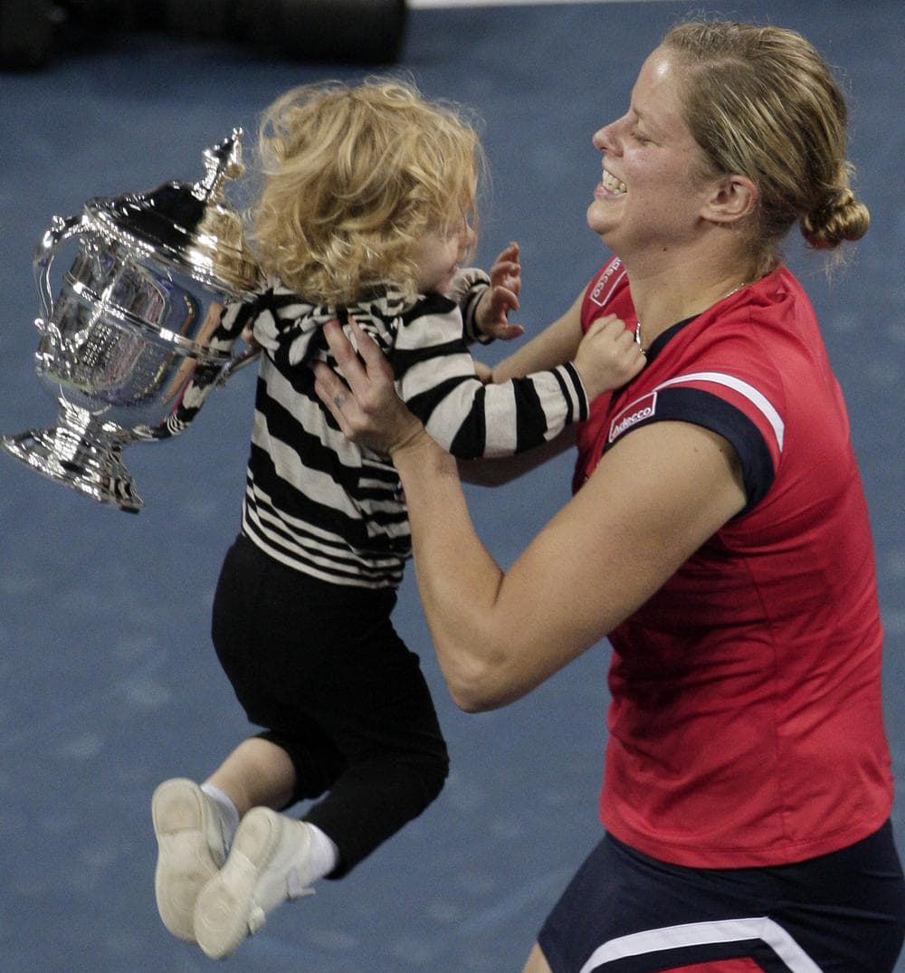 Kim Clijsters of Belgium lifts her daughter Jada after winning the women's championship over Caroline Wozniacki, of Denmark, at the U.S. Open tennis tournament in New York, Sunday, Sept. 13, 2009. (AP Photo/Kathy Willens)