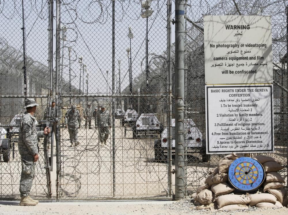 A member of the US military stands by a gate at Camp Bucca, in Iraq, Wednesday, Sept. 16, 2009. The U.S. military on Wednesday closed the desert prison camp, once its largest lockup in Iraq, as it forges ahead with plans to release detainees or transfer them to Iraqi custody.  (AP)