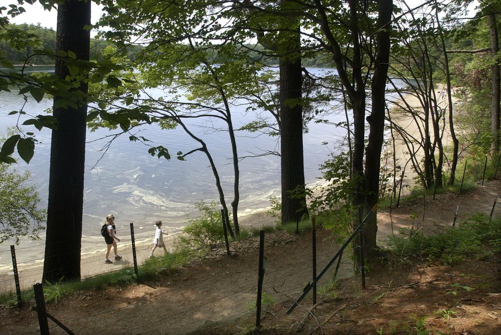 A woman and young boy walk around Walden Pond in Concord, Mass., June 20, 2003. It was to this peaceful New England lake that a remarkable individual came to live alone, clearing a spot for a one-room cabin.  (AP Photo/Elise Amendola)