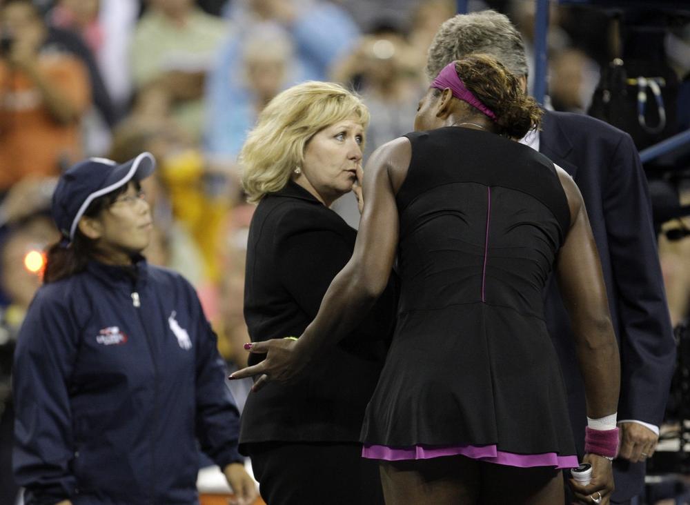 Serena Williams talks to officials after arguing with a line judge during her match against Kim Clijsters at the U.S. Open on Saturday. (AP)