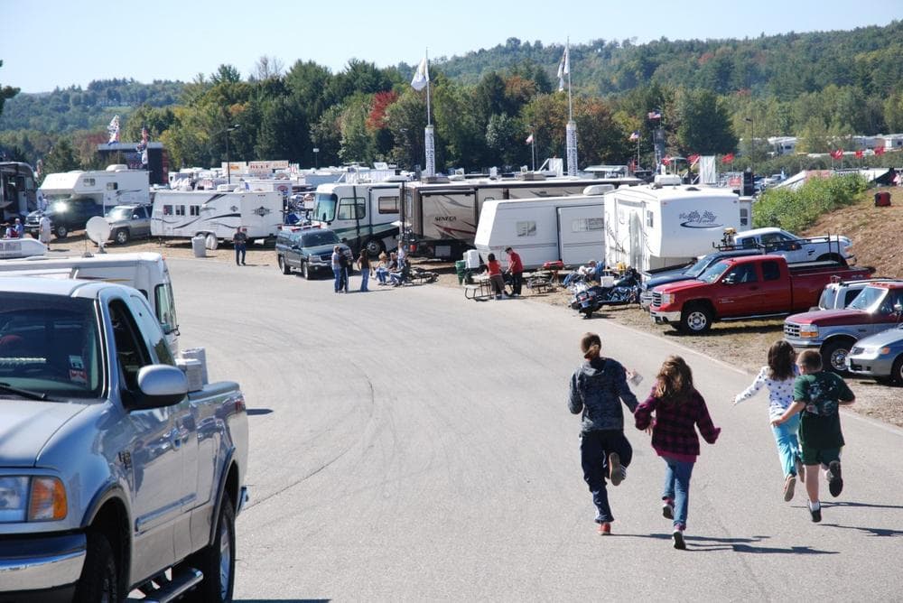 Whitney Emerson, Alicia Deering, Travis Emerson, Renee Deering, of Gorham, Maine, in the Reserved RV area of the New Hampshire Motor Speedway. The waiting list can be long to get a spot here. (Andrew Phelps/WBUR)