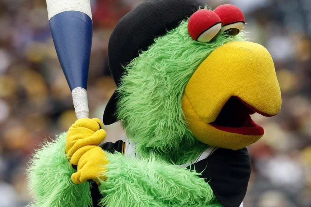 The Pittsburgh Pirates' mascot, the Pirate Parrot, plays with a large bat before the baseball game against the Cincinnati Reds  in Pittsburgh,  Sunday, Aug. 23, 2009. (AP Photo/Keith Srakocic)
