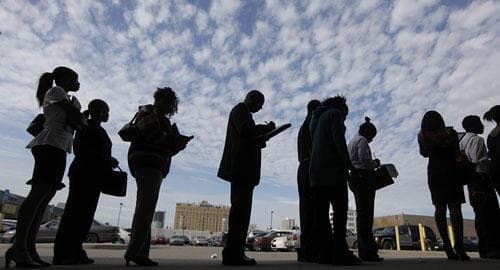 Job seekers fill out applications for positions at a new bar and restaurant while standing in line in Detroit, Sept. 25, 2009. (AP Photo/Paul Sancya)