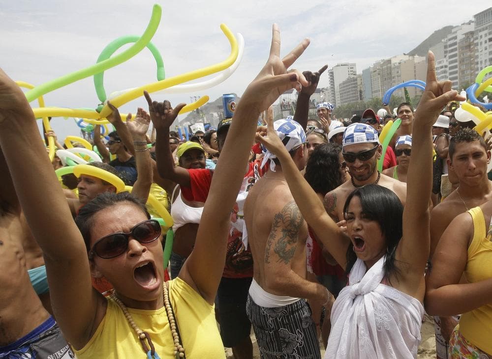 Rio fans celebrate after their city made it through another round for the nomination of host city for the 2016 Olympics at the Copacabana beach in Rio de Janeiro on Friday. (AP)