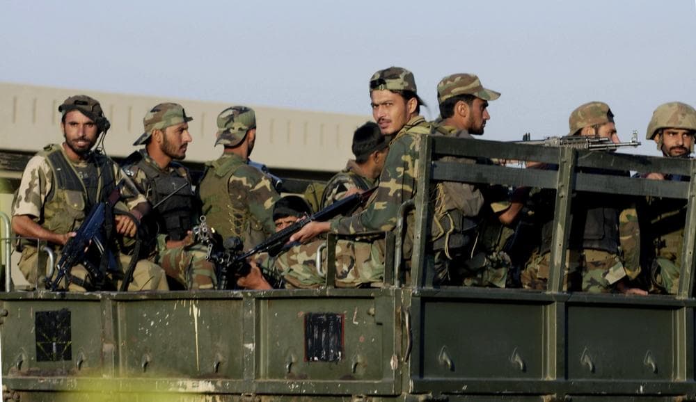 Pakistani army troops return to base camp after conducting an operation at their own army&#039;s headquarters in Rawalpindi, Pakistan on Sunday. Pakistani commandos raided their own army&#039;s headquarters Sunday to free 30 people held hostage by Islamist fighters. (AP/Anjum Naveed)