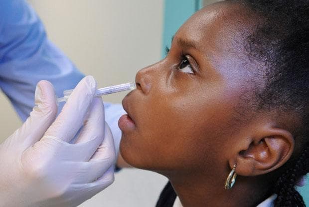 Asia Johnson, 6, of Boston, receives an intranasal H1N1 vaccine at the primary care clinic at Children's Hospital on Friday. (Lisa Poole/AP)