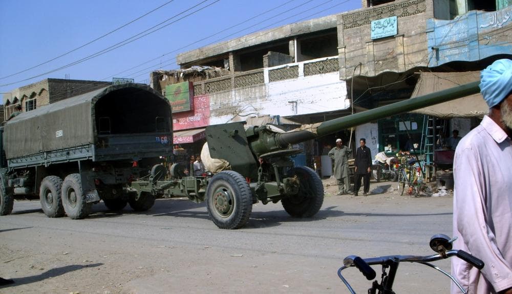 A Pakistan army truck transporting heavy artillery passes through the main bazaar of Tank, a town on the edge of Pakistan troubled tribal region South Waziristan, Saturday.  (AP/Ihsan Ahmed)