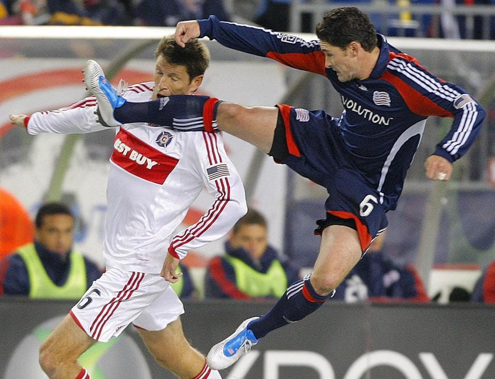 New England Revolution&#039;s Jay Heaps, right, kicks Chicago Fire defender Brandon Prideaux, left, in the face while leaping for a free ball during the first half of their MLS soccer match in Foxborough, Saturday night.  (AP Photo/Stephan Savoia)