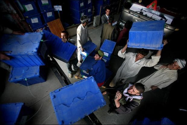 Workers load ballot boxes on to trucks at the Independent Election Commission compound in Kabul, Afghanistan. (Altaf Qadri/AP)