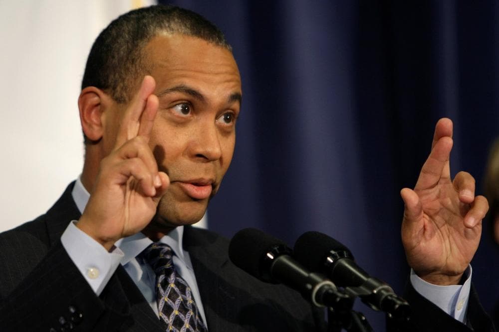 Gov. Deval Patrick crossed his fingers while talking about funding from the proposed federal stimulus plan in Boston on Feb. 11. (Charles Krupa/AP)