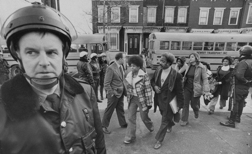Buses arrive at South Boston High School, Jan. 8, 1975 as classes resume at the racially troubled institution. Police were on hand to provide protection as black students arrived. (AP)