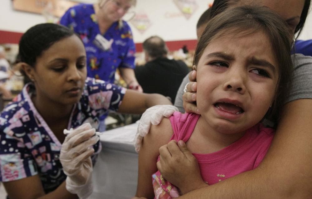 Brianna Jones, 4,  gets a hug from her mother, Jessica Ordonez, as Jones gets a dose of the H1N1 vaccine Saturday in Phoenix. (AP Photo/Ross D. Franklin)