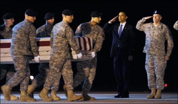 President Obama salutes as a team carries the transfer case containing the remains of Army Sgt. Dale R. Griffin of Terre Haute, Ind., during a dignified transfer at Dover Air Force Base. (Susan Walsh/AP)