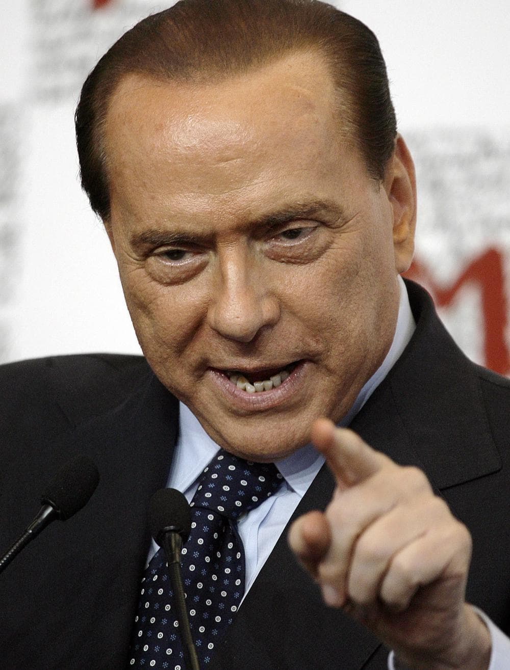 FILE - In this Sept. 8, 2009 file photo Italian premier Silvio Berlusconi gestures at the opening of a textile industry fair in Milan, Italy. Italian Silvio Berlusconi says he was &quot;astounded&quot; by a court ruling ordering his Fininvest holding company to pay ?750 million ($1 billion) to a rival for its controversial 1990s takeover of the Mondadori publishing house. The conservative premier and media mogul on Monday, Oct. 5, 2009 criticized last week's ruling and implied it was politically motivated. In a statement, he called the ruling &quot;a judicial absurdity&quot; and said he would continue as premier until the end of his five-year mandate. (AP)