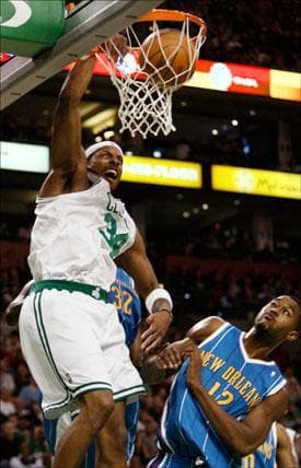 Boston Celtics forward Paul Pierce dunks on New Orleans Hornets center Hilton Armstrong during the first half of the game on Sunday. (Winslow Townson/AP)