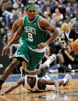 Rajon Rondo chases a loose ball as Timberwolves' Jonny Flynn watches from the floor after his failed effort to get the ball on Wednesday. (Jim Mone/AP)
