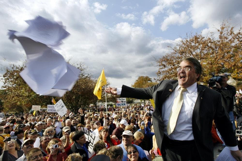 Rep. John Culberson, R-Texas, throws the health care bill to the crowd on Capitol Hill in Washington, Thursday, during a health care reform rally. (AP)