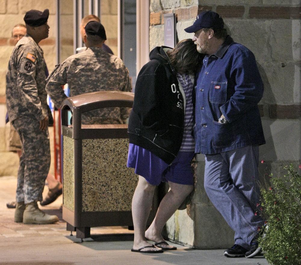 U.S. Army soldiers are seen at rear as Jamie Casteel, left, front, and her husband Scotty, right, of Duncan, Okla., stand outside the emergency room at Scott &amp; White hospital in Temple, Texas, Thursday Nov. 5, 2009, waiting to hear news of their son-in-law, U.S. Army soldier Matthew Cooke, who was injured Thursday in the shooting at Fort Hood. (AP)