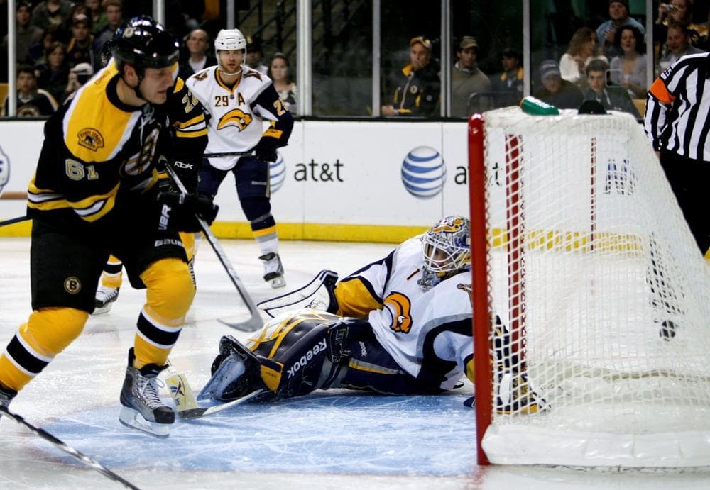 Bruins&#039; Byron Bitz, left, scores on Sabres&#039; Jhonas Enroth in the second period in Boston. (AP Photo/Michael Dwyer)
