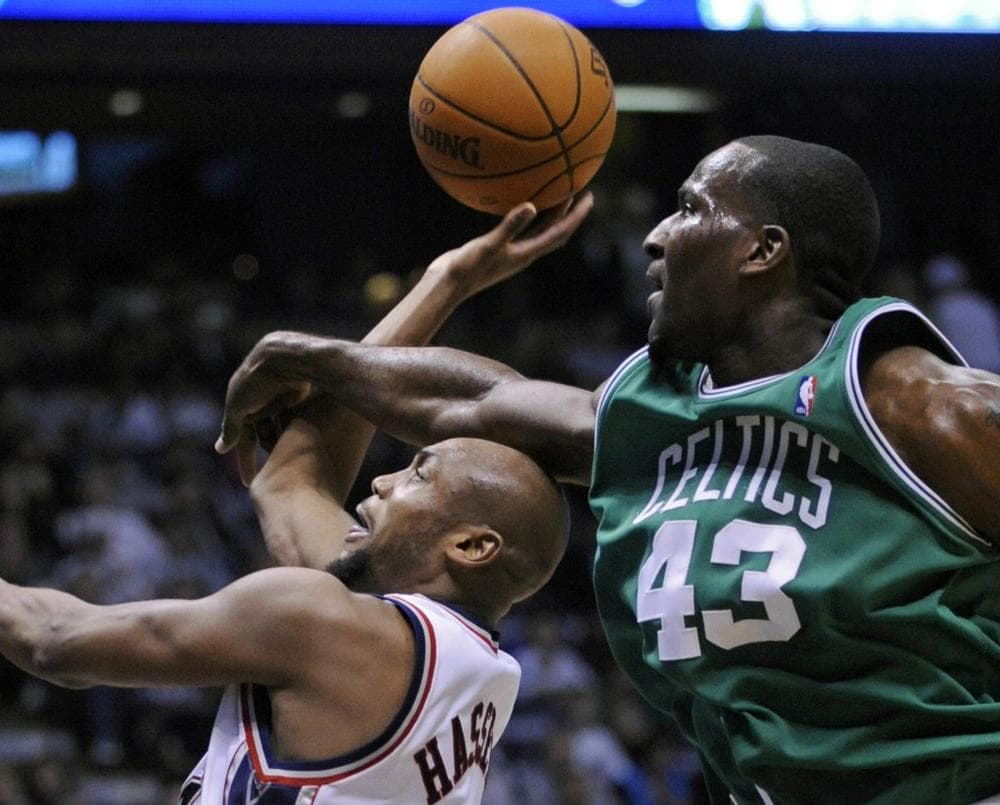 New Jersey Nets&#039; Trenton Hassell, left, is fouled by Boston Celtics&#039; Kendrick Perkins during the second quarter. (AP Photo/Bill Kostroun)