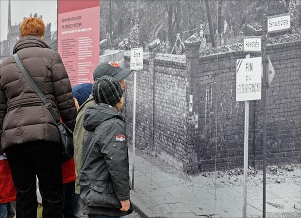 Children look at historical photo exhibits during a commemoration ceremony for the 20th anniversary of the fall of the Berlin Wall at the memorial &quot;Bernauer Strasse&quot; in Germany. (Fabian Bimmer/AP)