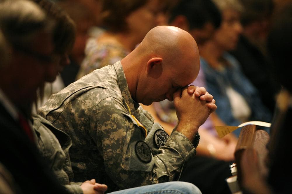 U.S. Army Sgt. Andrew Sobecky bows his head during the singing of &quot;Amazing Grace,&quot; during a prayer service at First Baptist Church, Sunday, Nov. 8, 2009, in Killeen, Texas. Governor Rick Perry delivered a message to attendees from area churches during the service that honored the dead and wounded from last weeks mass shooting on Fort Hood.  (AP)