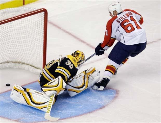 Florida Panthers left wing Corey Stillman pokes the puck past Bruins goalie Tim Thomas during the shootout for the only goal of the game on Thursday. (Charles Krupa/AP)