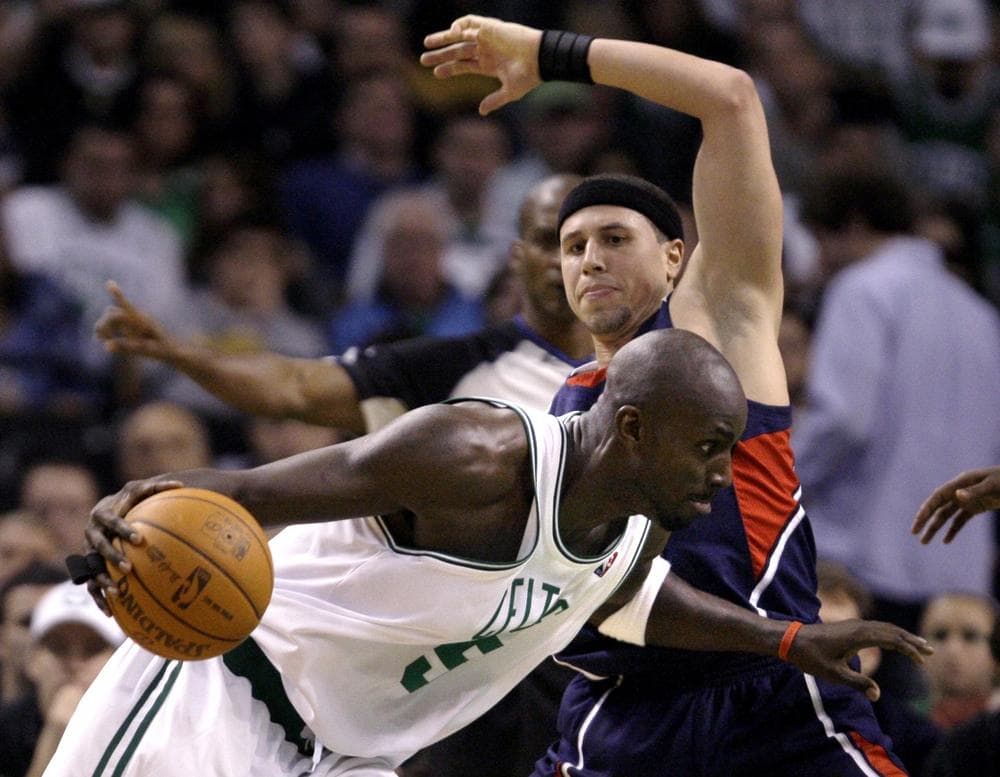 Celtics forward Kevin Garnett, bottom, collides with Hawks guard Mike Bibby in the second half in Boston, Friday. (AP Photo/Charles Krupa)