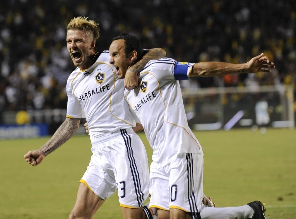 Los Angeles Galaxy's David Beckham, left, celebrates teammate Landon Donovan's penalty goal kick during the second half of their MLS Western Conference Championship soccer match against the Houston Dynamo, Nov. 13, in Carson, Calif. (AP)