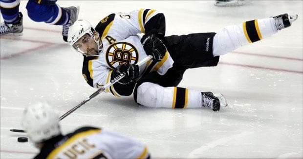 Patrice Bergeron tries to get his stick on the puck as he falls to the ice during the third period on Monday. (Jeff Roberson/AP)