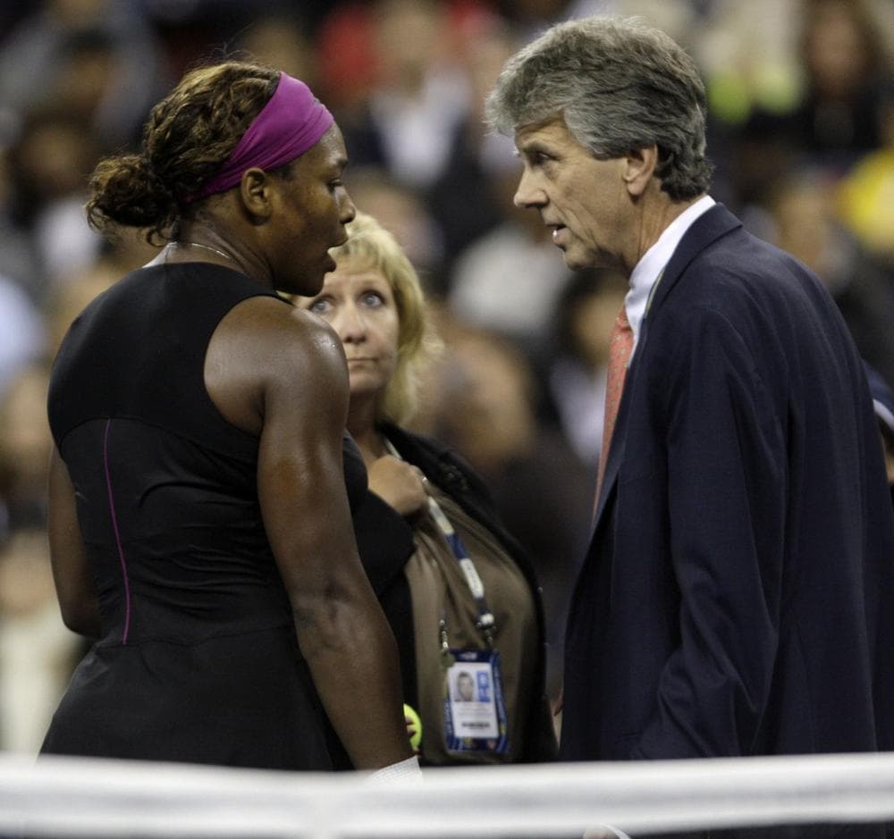 Serena Williams talks to officials after arguing with a line judge over a foot fault during her match against Kim Clijsters at the U.S. Open in September. (AP)