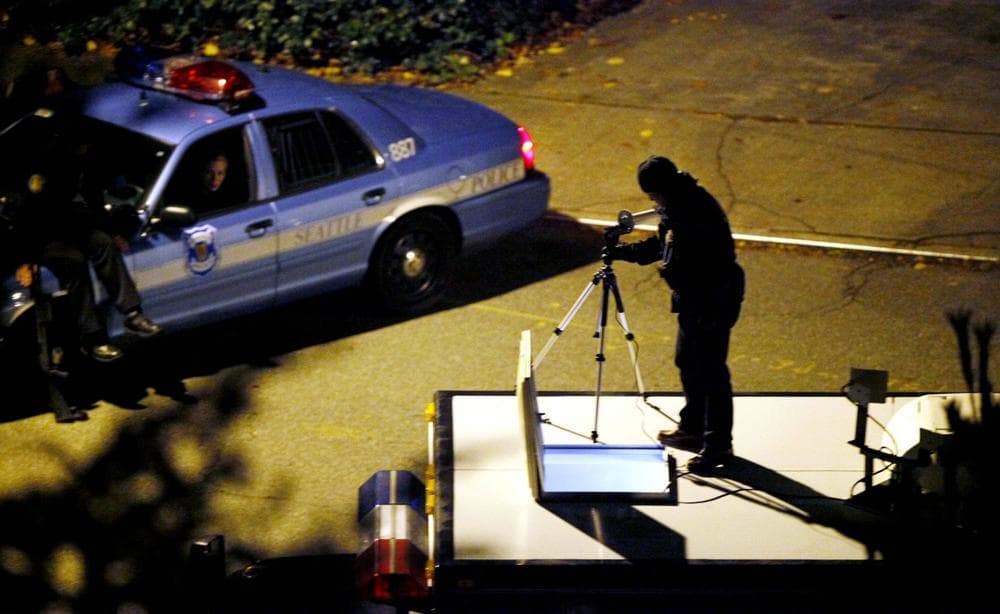 Police set up equipment atop a SWAT vehicle near a house police had surrounded during a search for Maurice Clemmons in the early morning hours Monday in Seattle. (Elaine Thompson/AP)