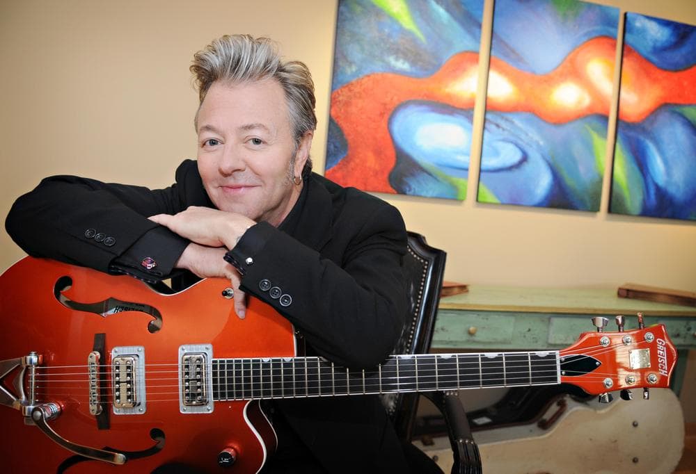 In this Sept. 18, 2009 photo, musician Brian Setzer poses at home with his guitar in his Minneapolis condo. Setzer, leader of the Brian Setzer Orchestra and a fan of film noir, is out with a new CD titled &quot;Songs from Lonely Avenue,&quot; which is a tribute to film noir. (AP)