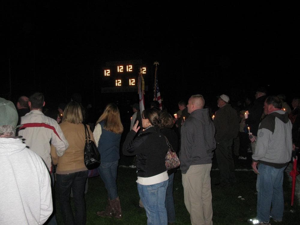Kyle VanDeGiesen's Number 12 lights the scoreboard during a candlelight vigil in North Attleborough