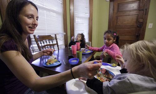 Food stamp recipient Lisa Zilligen, 28, serves lunch to her three children &mdash; Miles, 20 months, Olivia, 6, and Danielle, 8 &mdash; in her home in Chicago, Nov. 23, 2009. (AP) 