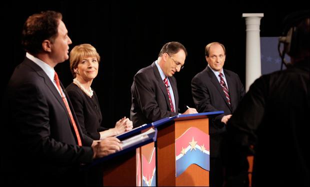 Boston Celtics co-owner Stephen Pagliuca, Attorney General Martha Coakley, City Year co-founder Alan Khazei and U.S. Rep. Michael Capuano chat and check their notes before the start of a televised debate at the WCVB-TV Channel 5 station on Tuesday. (Steven Senne/AP)