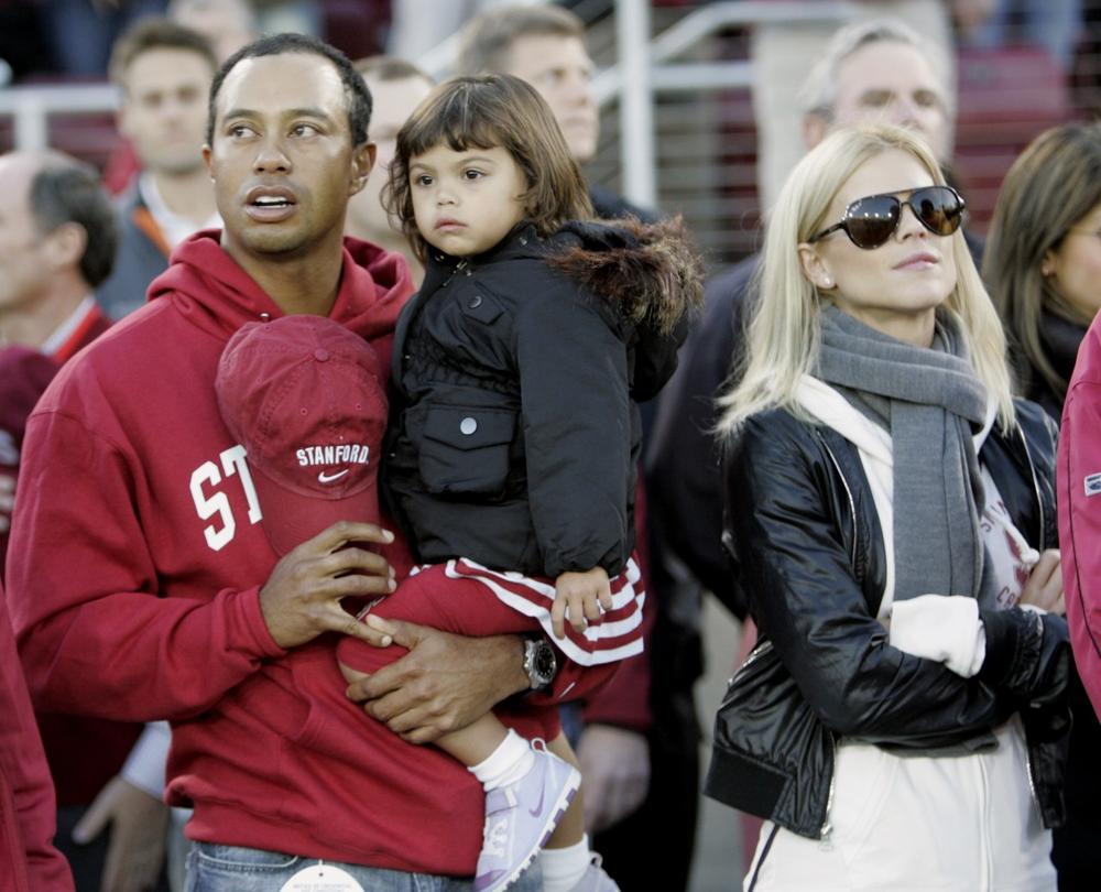 Tiger Woods stands with his daughter, Sam, and wife, Elin, before the start of an NCAA college football game between Stanford and California, in Stanford, Calif., Nov. 21. (AP)