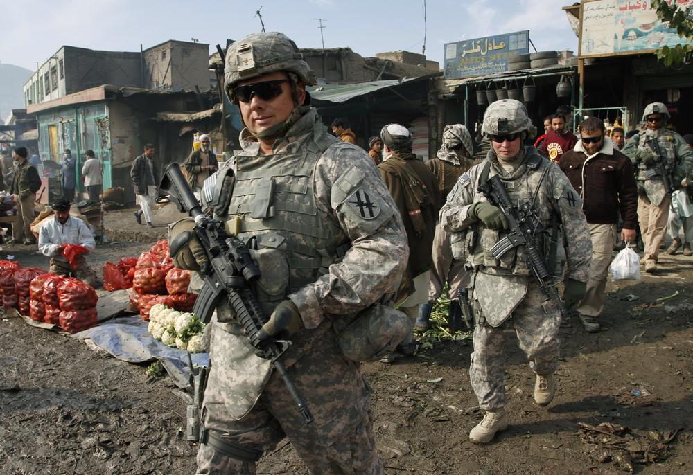 U.S. soldiers patrol through the heart of Kabul, Afghanistan on Wednesday, Dec. 2, 2009.  Many Afghans were still sleeping when President Barack Obama announced he was sending 30,000 more U.S. troops to the war. Gen. Stanley McChrystal, the top U.S. commander in Afghanistan, said NATO and U.S. forces would hand over responsibility for securing the country to the Afghan security forces &quot;as rapidly as conditions allow.&quot; Obama said if conditions are right, U.S. troops could begin leaving Afghanistan in 18 months. (AP)
