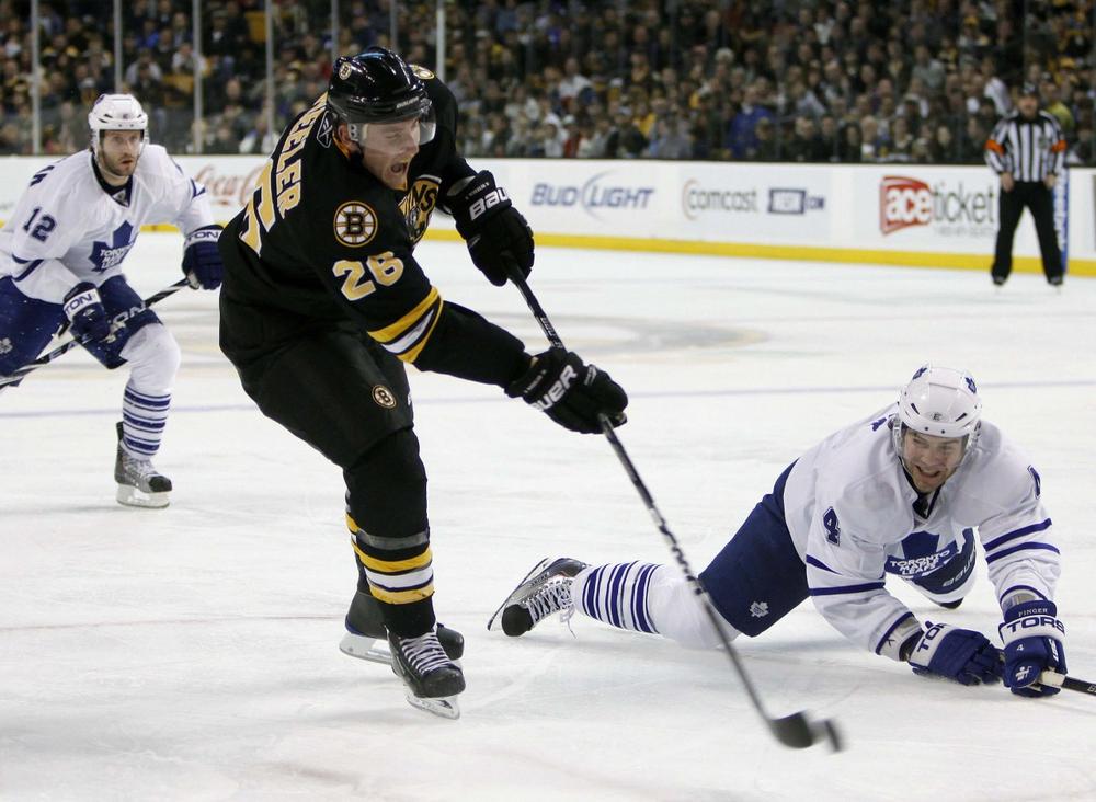 Maple Leafs&#039; Jeff Finger, right, tries to block a shot by  Bruins&#039; Blake Wheeler in the second period,  Saturday, in Boston. (AP Photo/Michael Dwyer)
