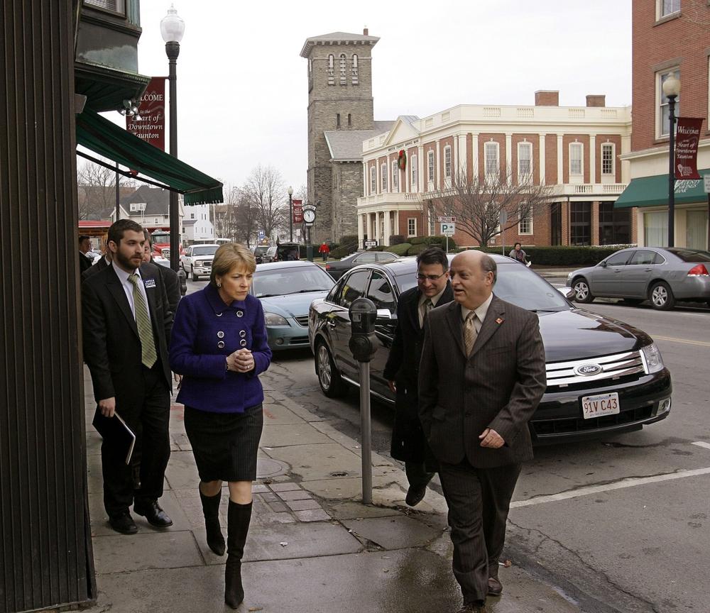 Attonrney General Martha Coakley walks with Taunton Mayor Charles Crowley as she campaigns outside Jimmy's Restaurant in Taunton on Monday. (AP) 